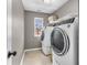 Bright laundry room features modern washer and dryer with window allowing for natural light at 6746 Wilmot Ln, Avon, IN 46123