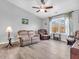 Cozy living room featuring neutral walls and a large window dressed with patterned curtains at 6746 Wilmot Ln, Avon, IN 46123
