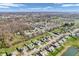 Overhead shot of the neighborhood featuring tree-lined streets and a tranquil pond at 6746 Wilmot Ln, Avon, IN 46123