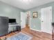 Bright home office with hardwood floors and neutral walls; a view into the hallway at 6746 Wilmot Ln, Avon, IN 46123