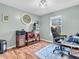 Bright office space with hardwood floors, a modern desk, and natural light from the window at 6746 Wilmot Ln, Avon, IN 46123