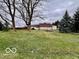 A view of the spacious backyard featuring a glimpse of the house, showing outdoor space at 7154 S 325 W, Jamestown, IN 46147