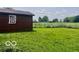 Image of home's backyard showing grass, trees, and fence line on a partly cloudy day at 7154 S 325 W, Jamestown, IN 46147