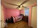 Bedroom featuring pink walls and wood floors at 7154 S 325 W, Jamestown, IN 46147