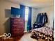 Bright bedroom features hardwood floors, neutral walls, and dresser and bed at 7154 S 325 W, Jamestown, IN 46147