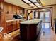 Traditional kitchen features an island, wood cabinets, and access to the backyard at 7154 S 325 W, Jamestown, IN 46147