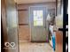 Laundry room featuring vinyl flooring, wallpaper, and a door to the exterior at 7154 S 325 W, Jamestown, IN 46147