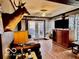 Cozy living room featuring hardwood floors, a ceiling fan, a TV, and a decorative deer head at 7154 S 325 W, Jamestown, IN 46147