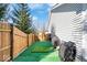 Backyard featuring a turf area, a putting green and full wooden privacy fence at 7260 Blue Ridge Dr, Noblesville, IN 46062
