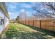 Large backyard with a lush lawn and a wooden fence, offering privacy and a spacious outdoor area at 7260 Blue Ridge Dr, Noblesville, IN 46062