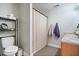 Bathroom featuring a toilet, vanity with dual sinks, neutral tile floors, and a shower with curtain at 7260 Blue Ridge Dr, Noblesville, IN 46062