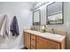 Bathroom featuring double sinks, framed mirrors, modern lighting, and a neutral color palette at 7260 Blue Ridge Dr, Noblesville, IN 46062