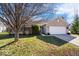 Charming brick home with a two-car garage and long driveway on a sunny day at 7260 Blue Ridge Dr, Noblesville, IN 46062
