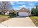 Charming brick home with a two-car garage and long driveway on a sunny day at 7260 Blue Ridge Dr, Noblesville, IN 46062