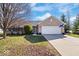Charming brick home with a two-car garage and long driveway on a sunny day at 7260 Blue Ridge Dr, Noblesville, IN 46062