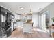Bright kitchen with white cabinets, stainless steel appliances, island and adjacent access to the backyard at 7260 Blue Ridge Dr, Noblesville, IN 46062