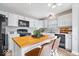Bright kitchen featuring white cabinets, modern appliances, butcher block island, and hardwood floors at 7260 Blue Ridge Dr, Noblesville, IN 46062