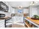 Bright kitchen featuring white cabinets, counter space, and modern appliances, with hardwood floors at 7260 Blue Ridge Dr, Noblesville, IN 46062