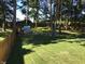 Large backyard with wooden fence and playhouse near lush trees at 7336 Hardin Oak Dr, Noblesville, IN 46062
