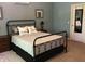 Bedroom with metal bed frame, dark wood furnishings, and light blue walls at 7336 Hardin Oak Dr, Noblesville, IN 46062