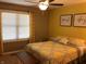 Bedroom featuring a patterned yellow comforter, wood accents, and bright natural light at 7336 Hardin Oak Dr, Noblesville, IN 46062