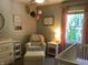 Bedroom with a crib, glider, and changing table, decorated with pink accents at 7336 Hardin Oak Dr, Noblesville, IN 46062