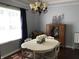 This dining room features a white table, hardwood floors, and a charming chandelier for stylish dining at 7336 Hardin Oak Dr, Noblesville, IN 46062