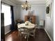 This dining room features a white table, hardwood floors, and a charming chandelier for stylish dining at 7336 Hardin Oak Dr, Noblesville, IN 46062