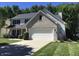 Charming two-story home with a large two-car garage and well-manicured lawn at 7336 Hardin Oak Dr, Noblesville, IN 46062