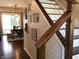 Foyer with hardwood floors, modern staircase, and a view into the dining room at 7336 Hardin Oak Dr, Noblesville, IN 46062