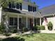 Inviting front porch with swing and brick accents, surrounded by lush landscaping at 7336 Hardin Oak Dr, Noblesville, IN 46062