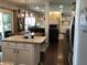 This kitchen boasts granite countertops, white cabinets, and opens into a living area with a fireplace feature at 7336 Hardin Oak Dr, Noblesville, IN 46062