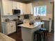 A modern kitchen featuring white cabinets, stainless steel appliances, granite countertops, and a kitchen island at 7336 Hardin Oak Dr, Noblesville, IN 46062