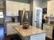 The modern kitchen features white cabinets, granite countertops, stainless steel appliances, and a pantry door at 7336 Hardin Oak Dr, Noblesville, IN 46062