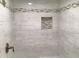 Stylish tiled shower featuring decorative niche for soaps and bath items at 7336 Hardin Oak Dr, Noblesville, IN 46062