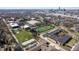 An aerial view shows a school campus, athletic fields, and downtown buildings in the distance on a clear day at 774 Woodruff Pl E Dr, Indianapolis, IN 46201
