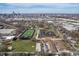 An aerial view shows a school campus, athletic fields, and downtown buildings in the distance on a clear day at 774 Woodruff Pl E Dr, Indianapolis, IN 46201