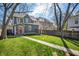 Spacious backyard with a lush lawn, mature trees, and a charming two-story home at 774 Woodruff Pl E Dr, Indianapolis, IN 46201