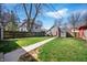 Expansive backyard featuring a well-maintained lawn and a walkway to a detached garage at 774 Woodruff Pl E Dr, Indianapolis, IN 46201