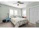 Comfortable bedroom features two windows, light green walls, carpet and ceiling fan at 774 Woodruff Pl E Dr, Indianapolis, IN 46201