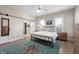 Bright bedroom featuring a sliding barn door, metal bed frame, ceiling fan and an accent rug at 774 Woodruff Pl E Dr, Indianapolis, IN 46201