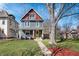 Charming two-story home with a well-manicured lawn and inviting yellow door at 774 Woodruff Pl E Dr, Indianapolis, IN 46201
