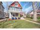 Charming two-story home featuring a well-manicured lawn, sidewalk, and lush yard at 774 Woodruff Pl E Dr, Indianapolis, IN 46201