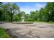A classic tiered fountain stands prominently in a circular area, surrounded by trees and a tranquil atmosphere at 774 Woodruff Pl E Dr, Indianapolis, IN 46201