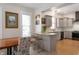 Open-concept kitchen with granite countertops, modern appliances, and a breakfast bar at 774 Woodruff Pl E Dr, Indianapolis, IN 46201