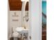 Charming powder room featuring a unique vanity, decorative shelves, and elegant fixtures at 774 Woodruff Pl E Dr, Indianapolis, IN 46201