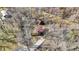 An aerial shot of a house with a long driveway, red roofs, and surrounded by many leafless trees at 7916 W 275 N, Boggstown, IN 46110