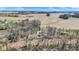 A sprawling aerial view of the property showcasing the surrounding farm fields and wooded areas at 7916 W 275 N, Boggstown, IN 46110