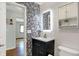 Bathroom with modern vanity, designer wallpaper, and lighted mirror at 7916 W 275 N, Boggstown, IN 46110