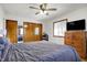 Inviting bedroom with natural light, a ceiling fan, and classic wood accents offers a comfortable retreat at 7916 W 275 N, Boggstown, IN 46110